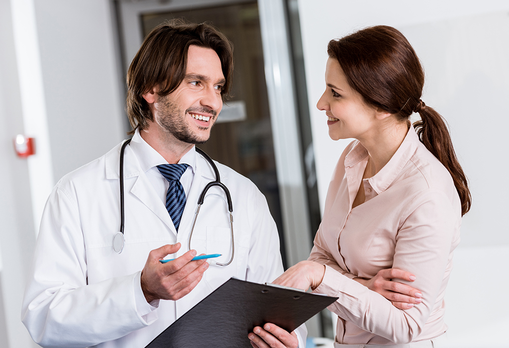 Doctor holding clipboard and talking